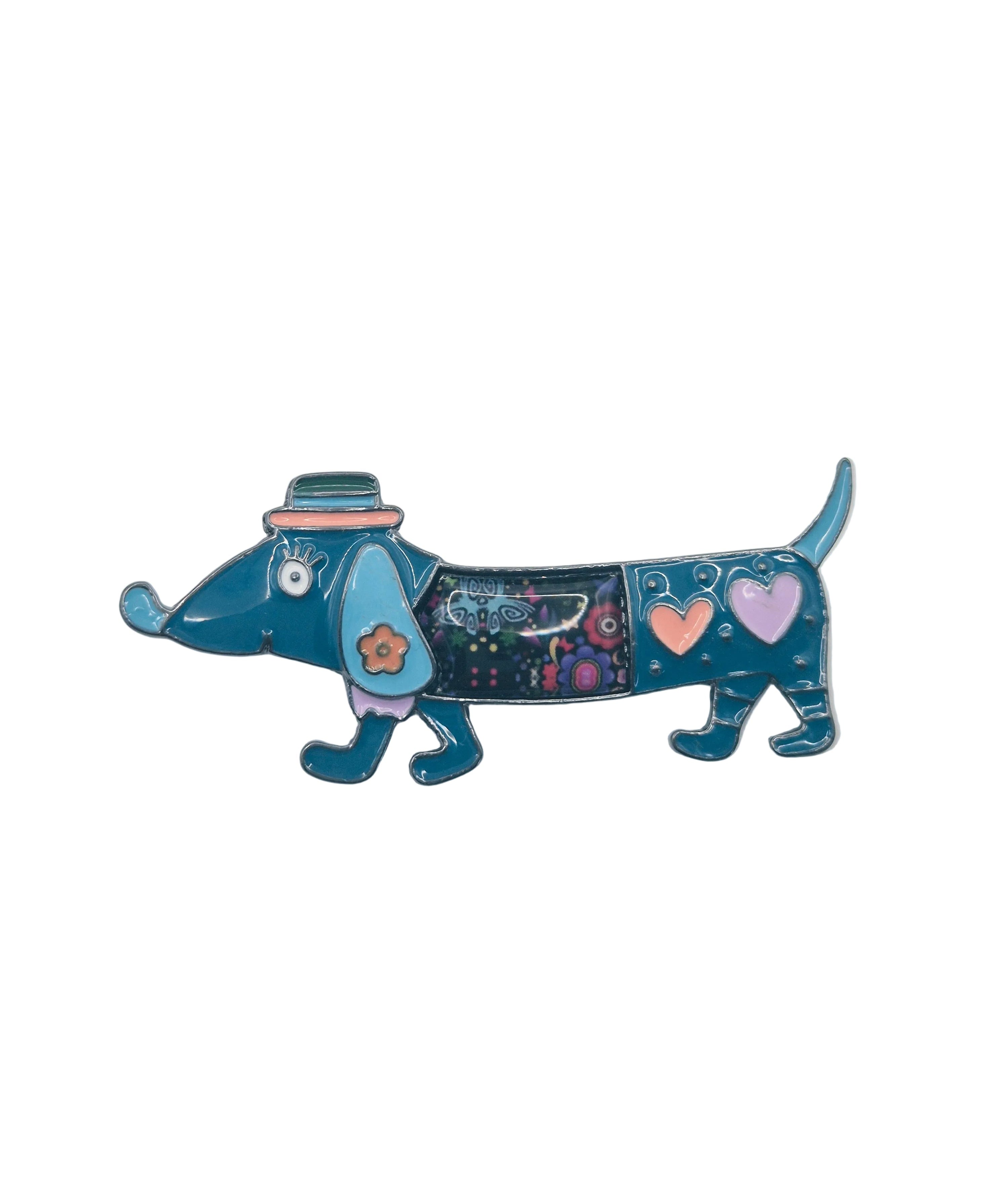 Blue dachshund dog brooch with hearts and floral design on  plain white background 