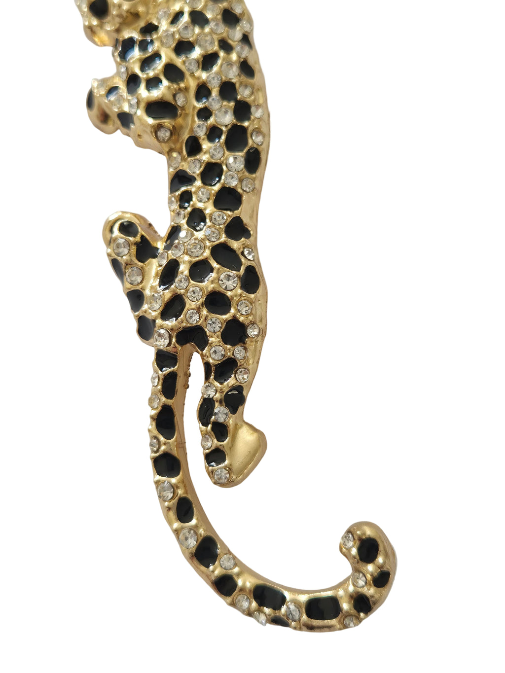 Gold and black leopard shaped brooch on a light gray background