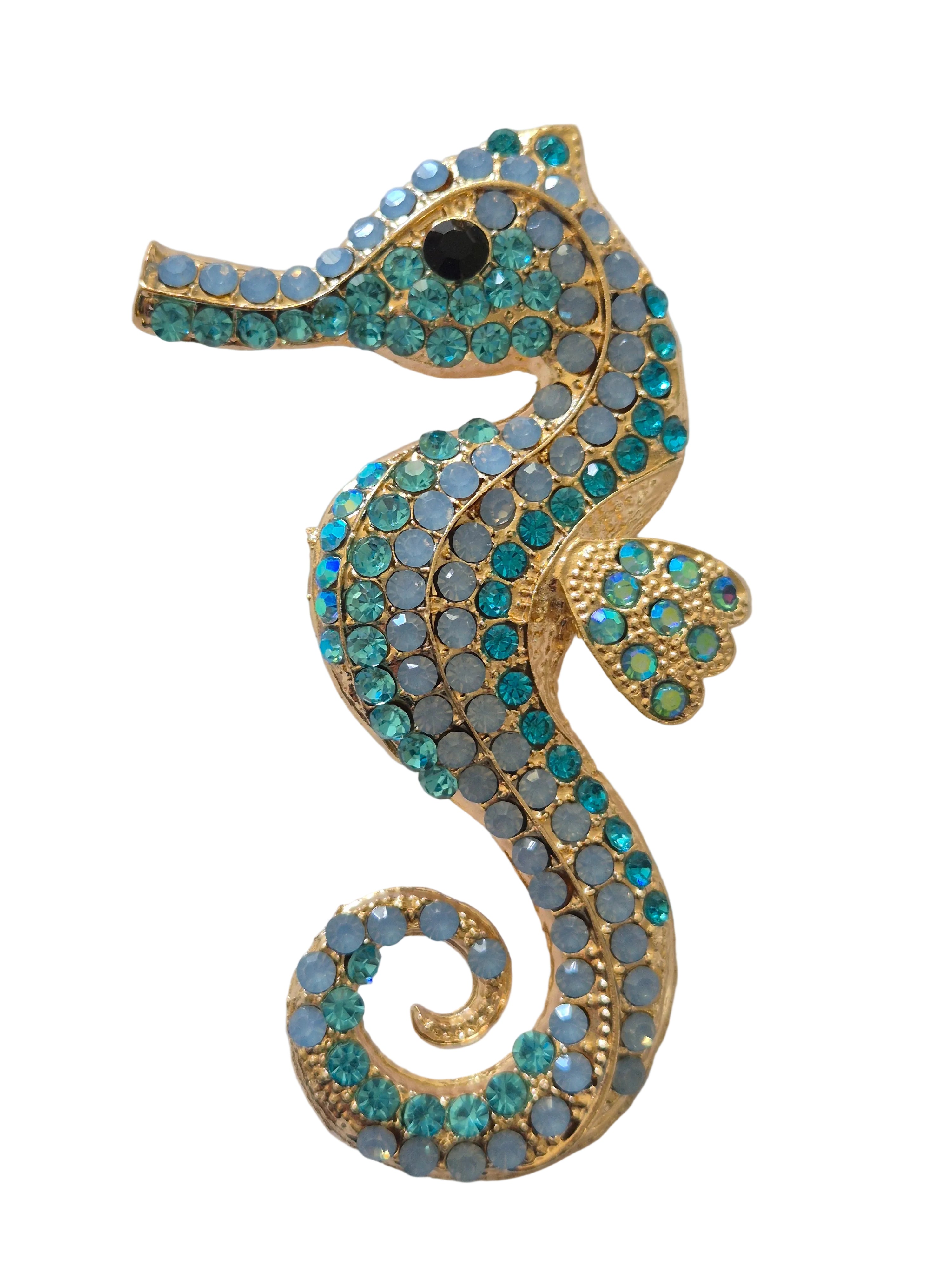 Decorative seahorse  brooch with gemstones on a white background
