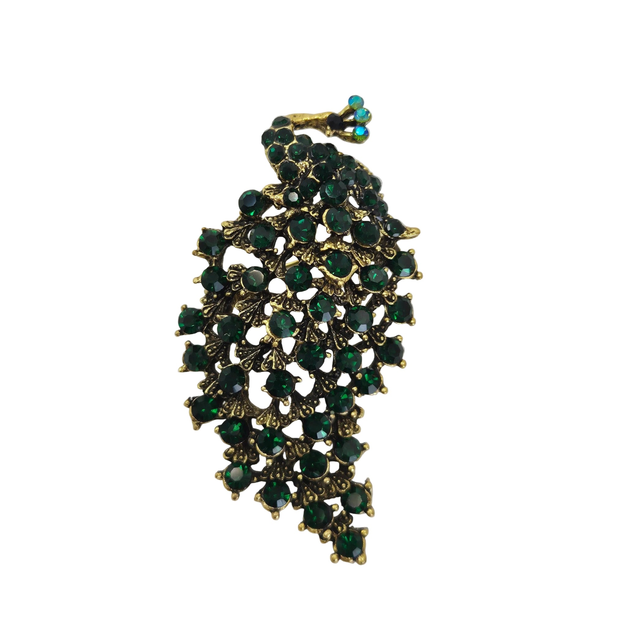 A vintage-style gold-tone peacock shaped brooch embellished with multiple round dark green rhinestones, shown on a plain white background.