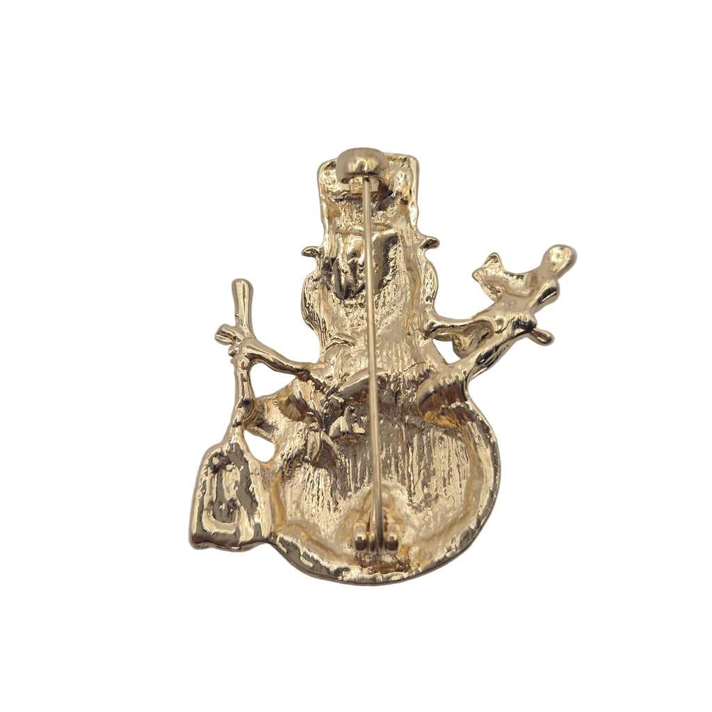 Reverse gold tone side of a snowman brooch with pin mechanism, displayed against a plain white background.