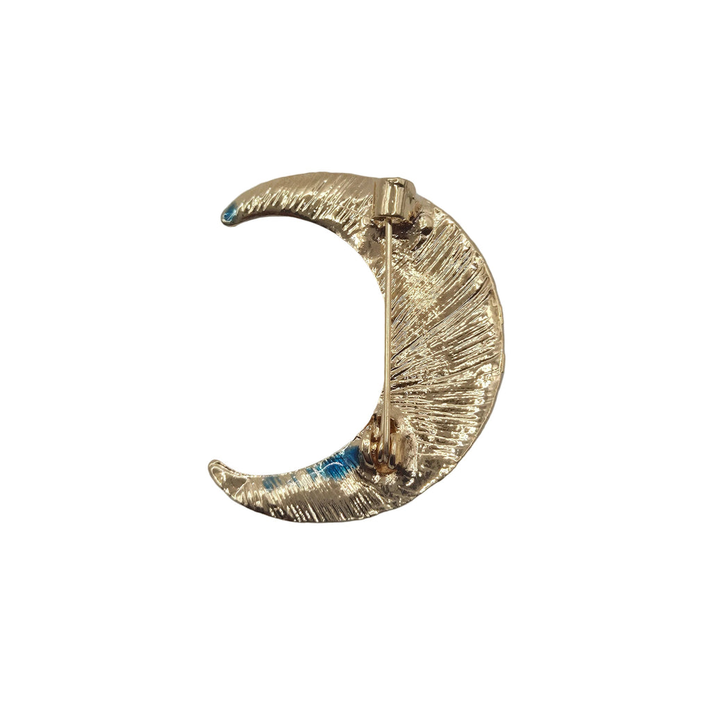 A gold crescent moon-shaped brooch with showing reverse side, shown on a plain white background.