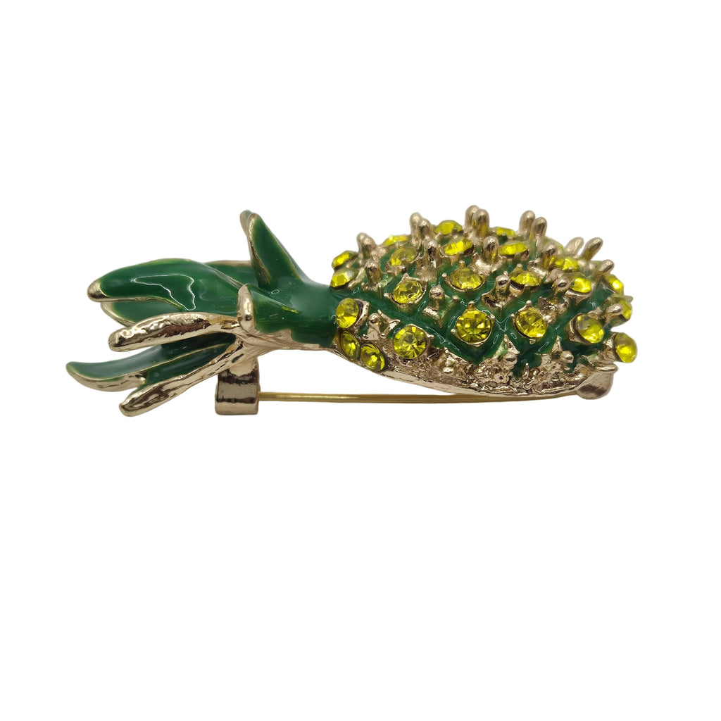 Pineapple-shaped brooch with green and yellow details on a white background