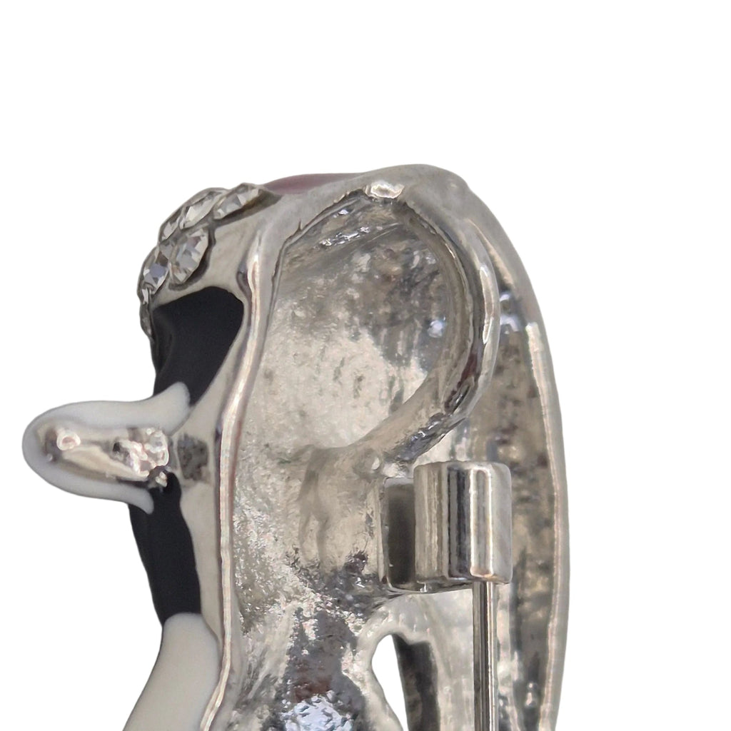 A penguin-shaped brooch shown on the reverse side. Displayed on a plain white background showing loop.