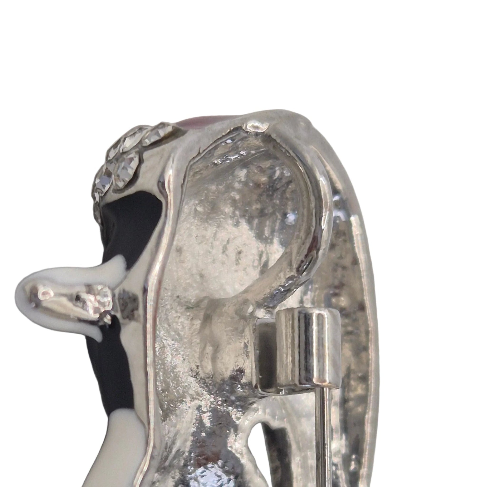 A penguin-shaped brooch shown on the reverse side. Displayed on a plain white background showing loop.