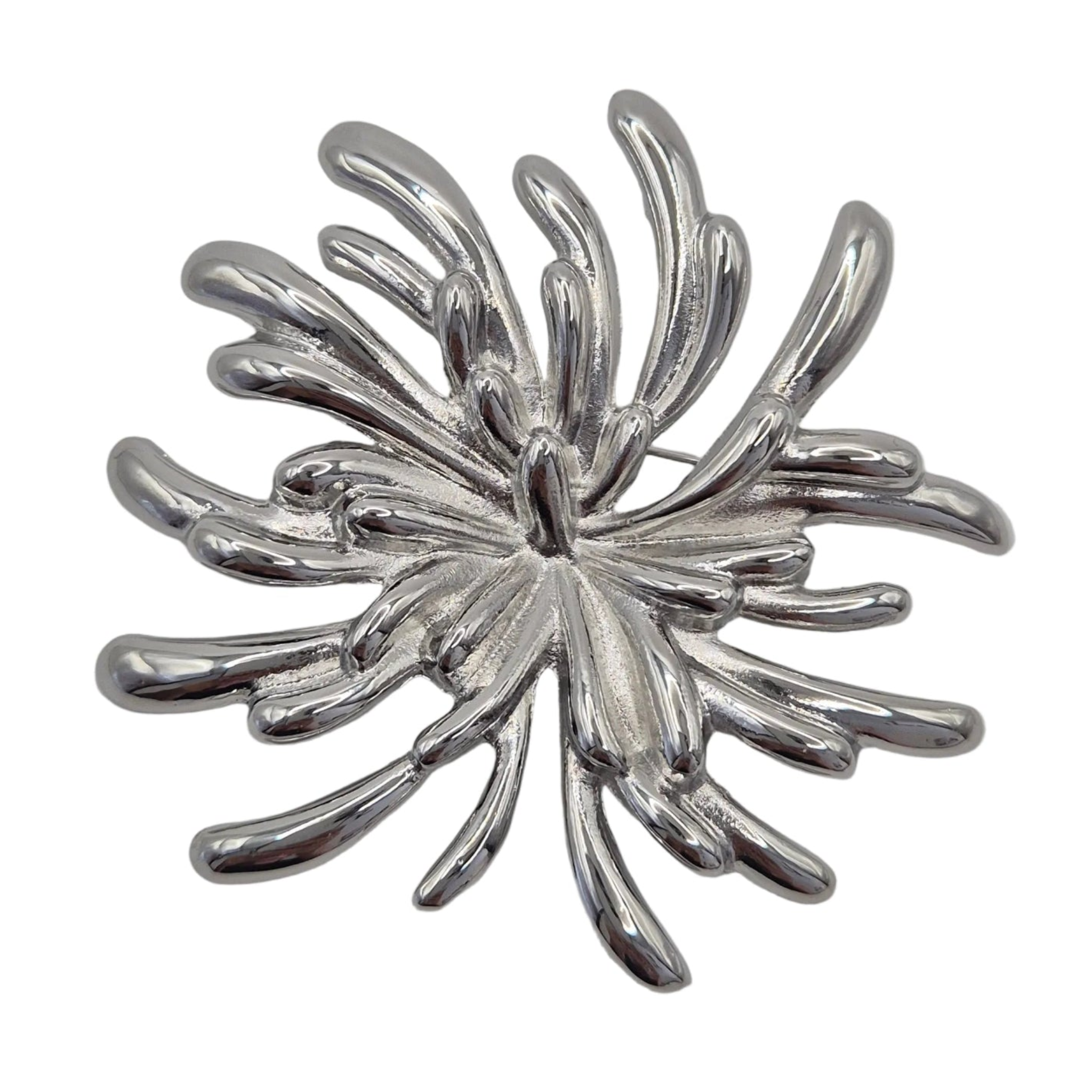 A silver toned metal firework burst brooch displayed against a plain white background.