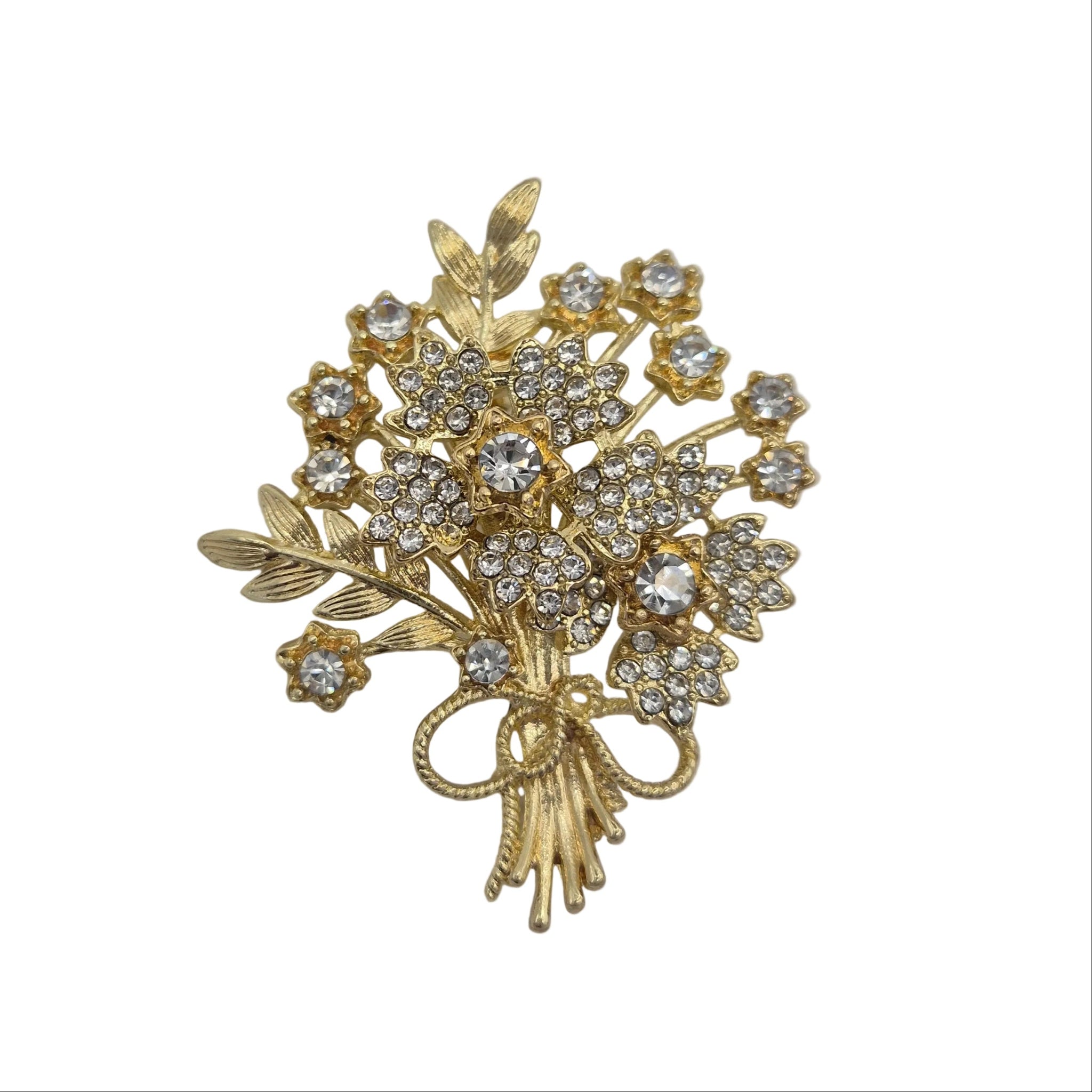 A gold-toned floral bouquet brooch with clear rhinestones, isolated on a white background.