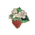 A red, white and gold, strawberry fruit and flowers brooch on a plain white background.