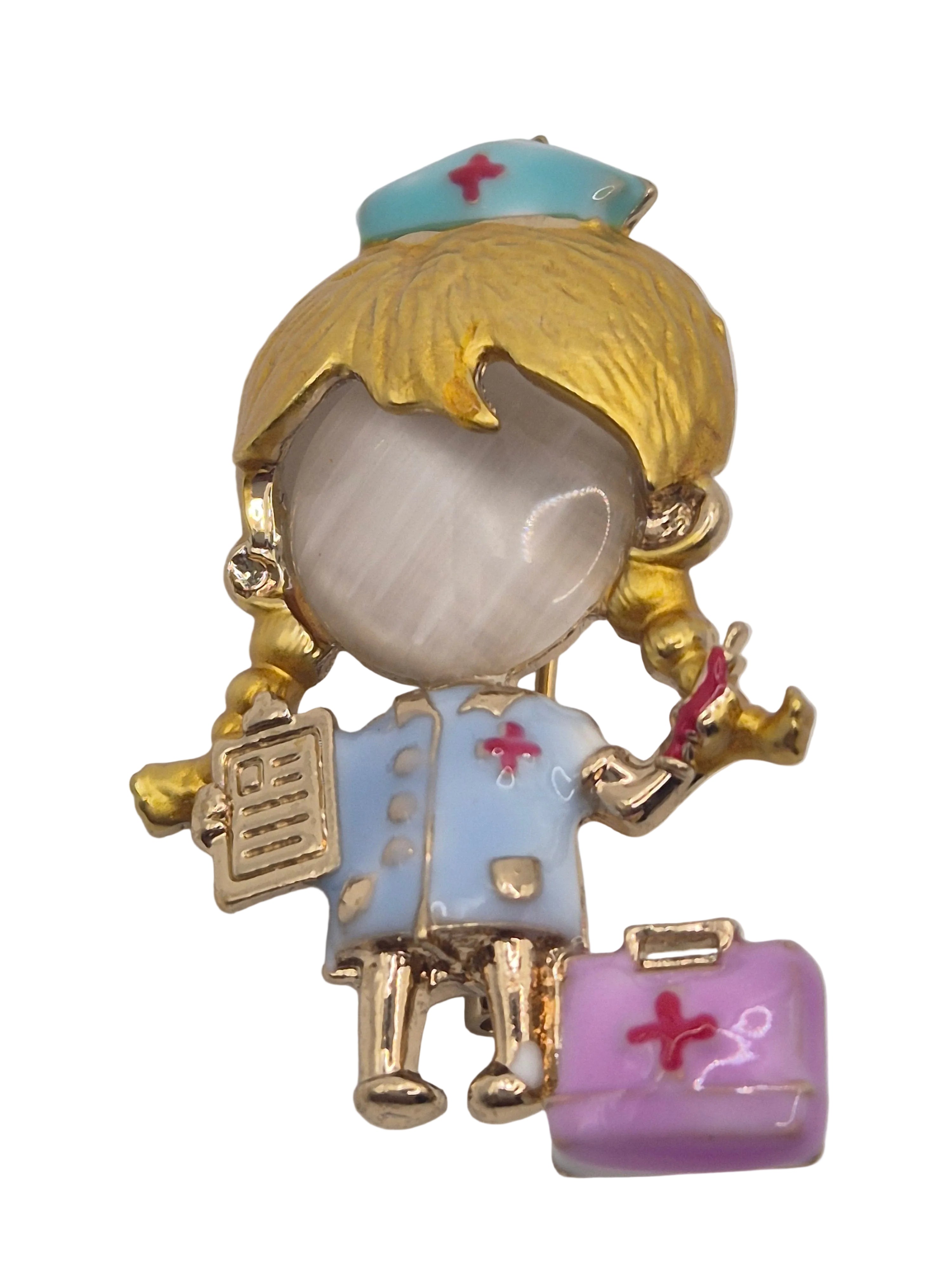 nurse brooch with gold, white, and pastel colors on a light gray background