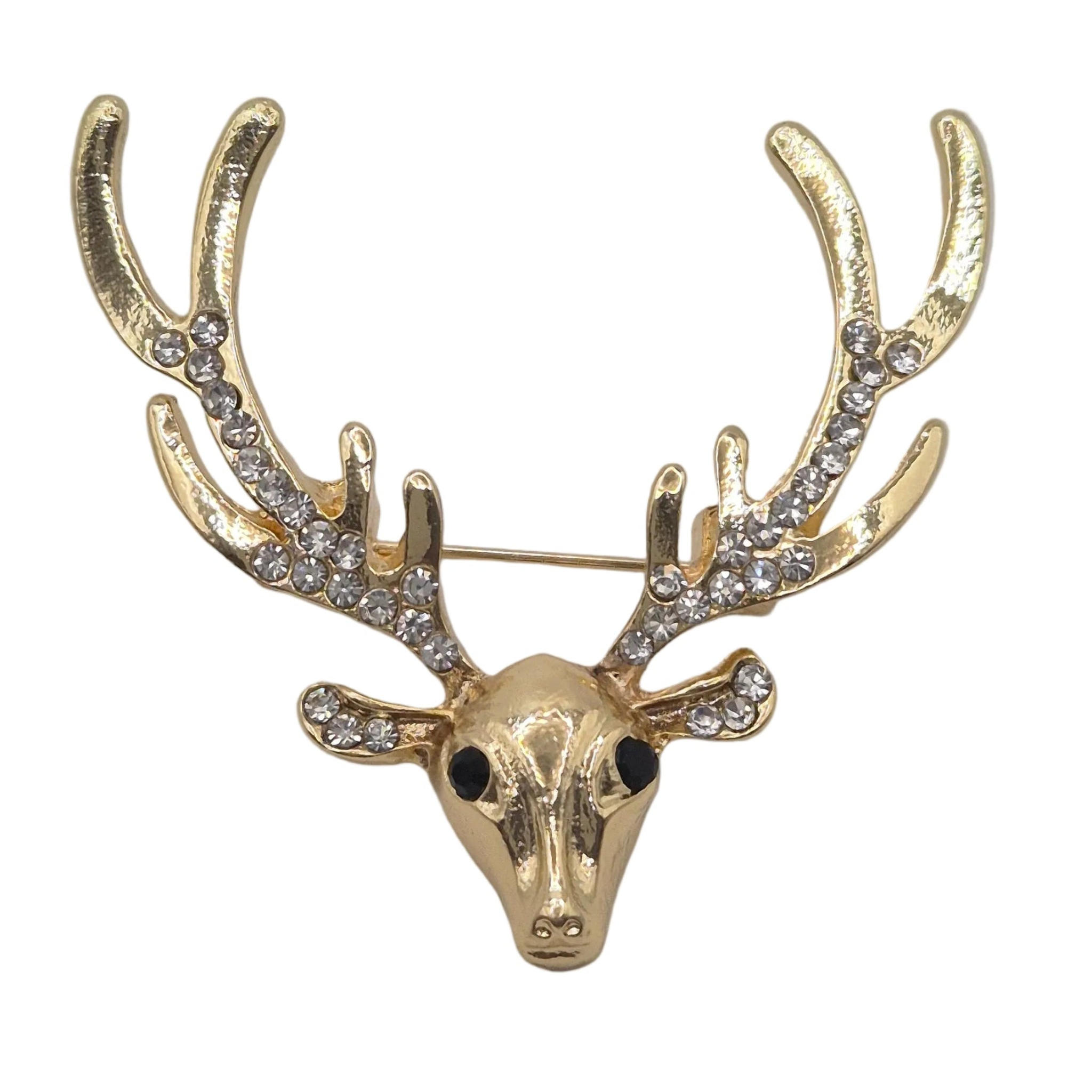 A gold deer head brooch with large antlers, embellished with clear rhinestones on the antlers and ears, and small black enamel eyes, shown on a plain white background.