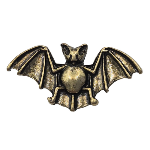 An antique bronze bat pin brooch with detailed wings and a textured finish, shown against a plain white background.