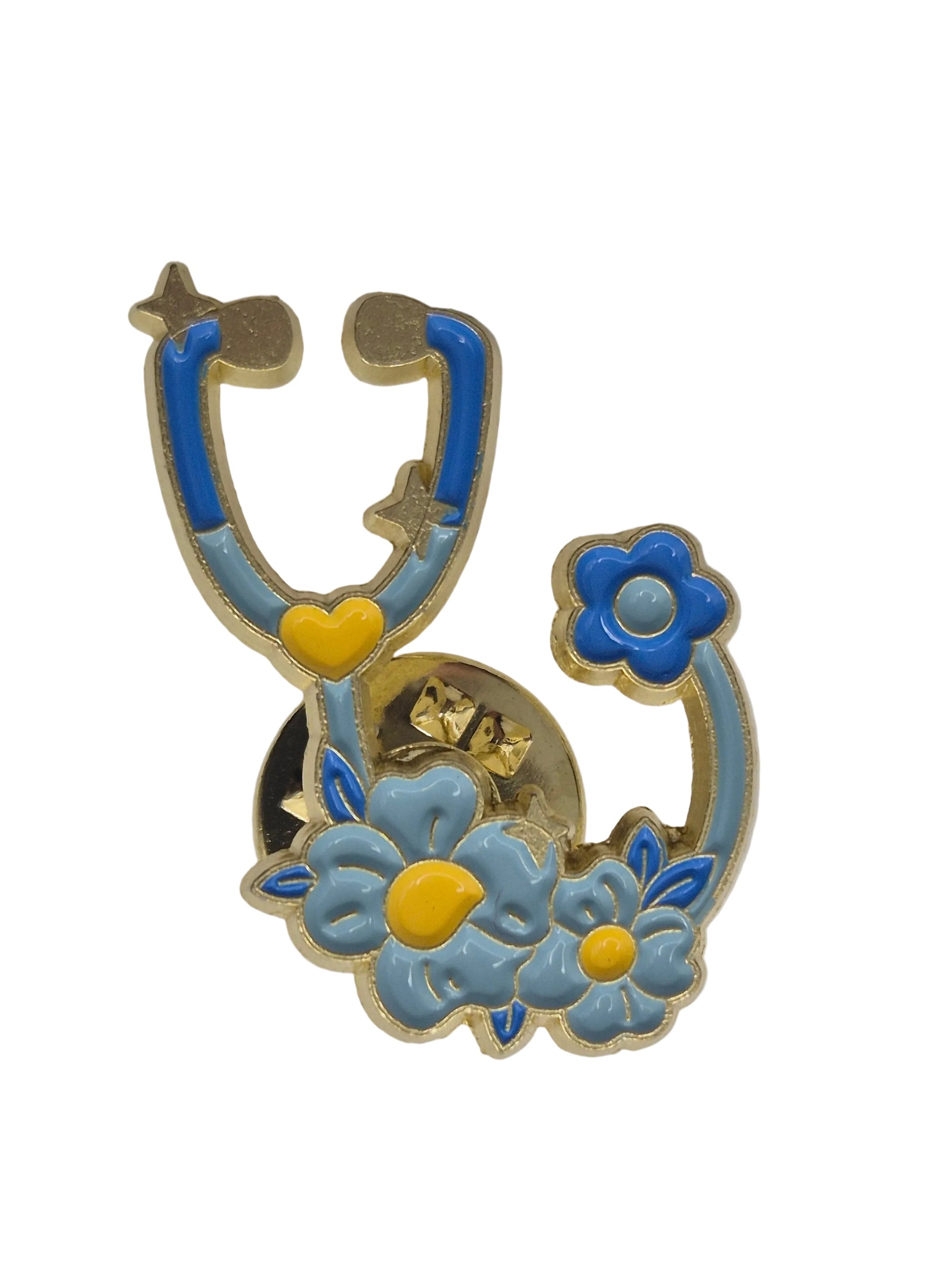 A decorative lapel pin shaped like a stethoscope with blue and light blue flowers and yellow centers, outlined in gold-toned metal, shown on a plain white background.