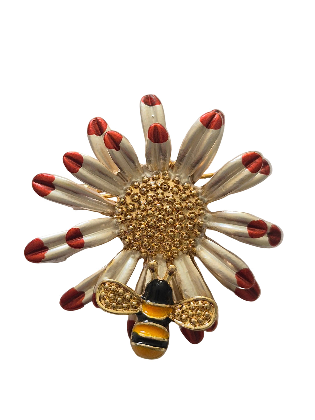 Decorative brooch with gold center, red accents, and bee design on a white background