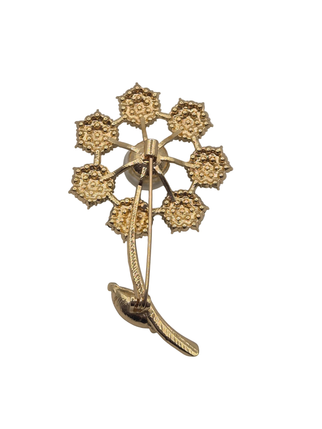 Gold brooch with floral design on a white background