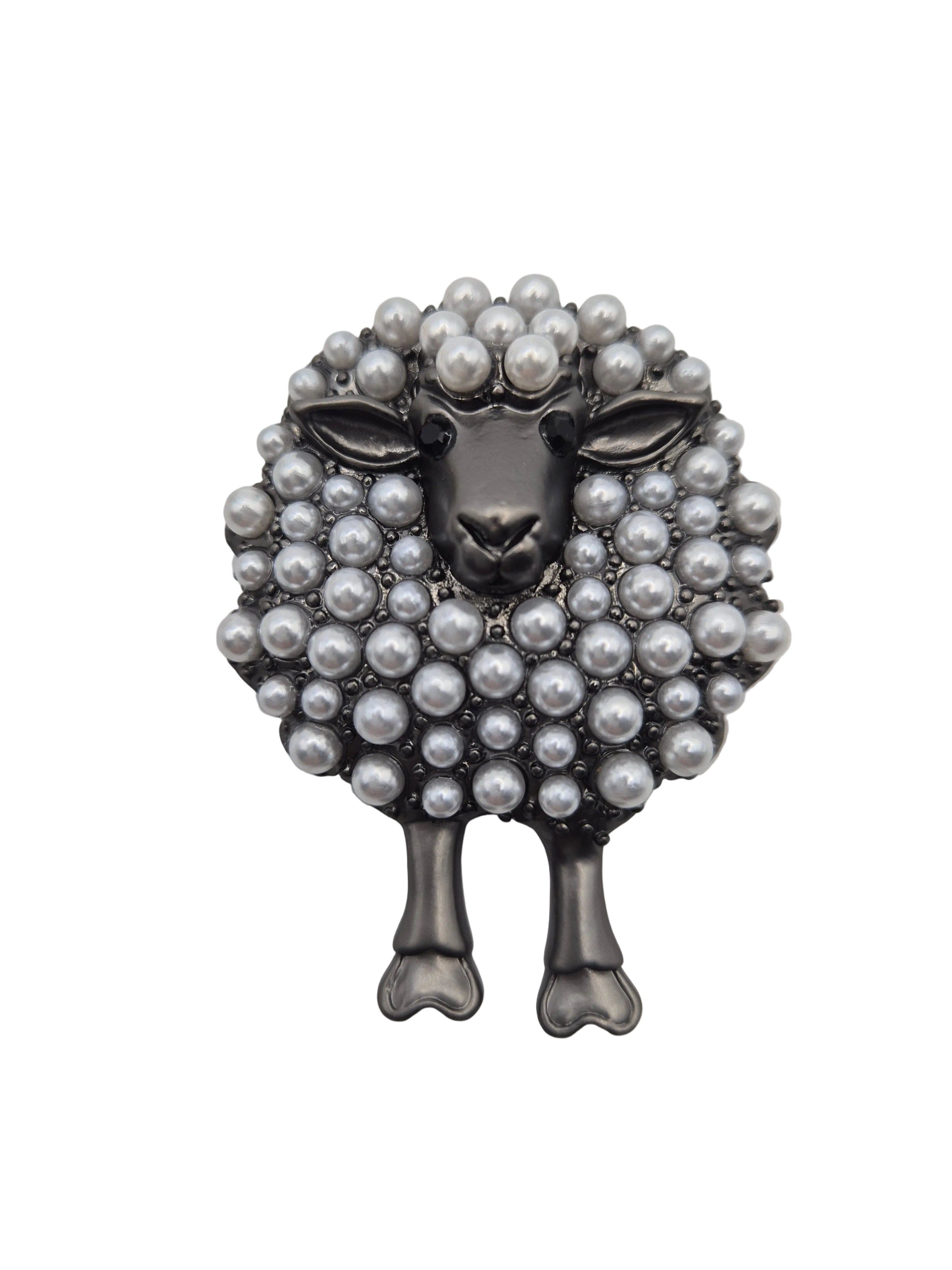 Sheep shaped brooch with pearl-like beads on a white background