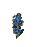 Blue floral brooch with green leaves on a white background