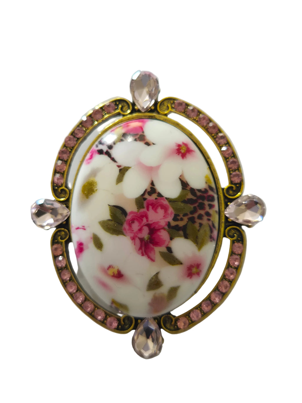 Decorative brooch with floral design and rhinestones on a light gray background