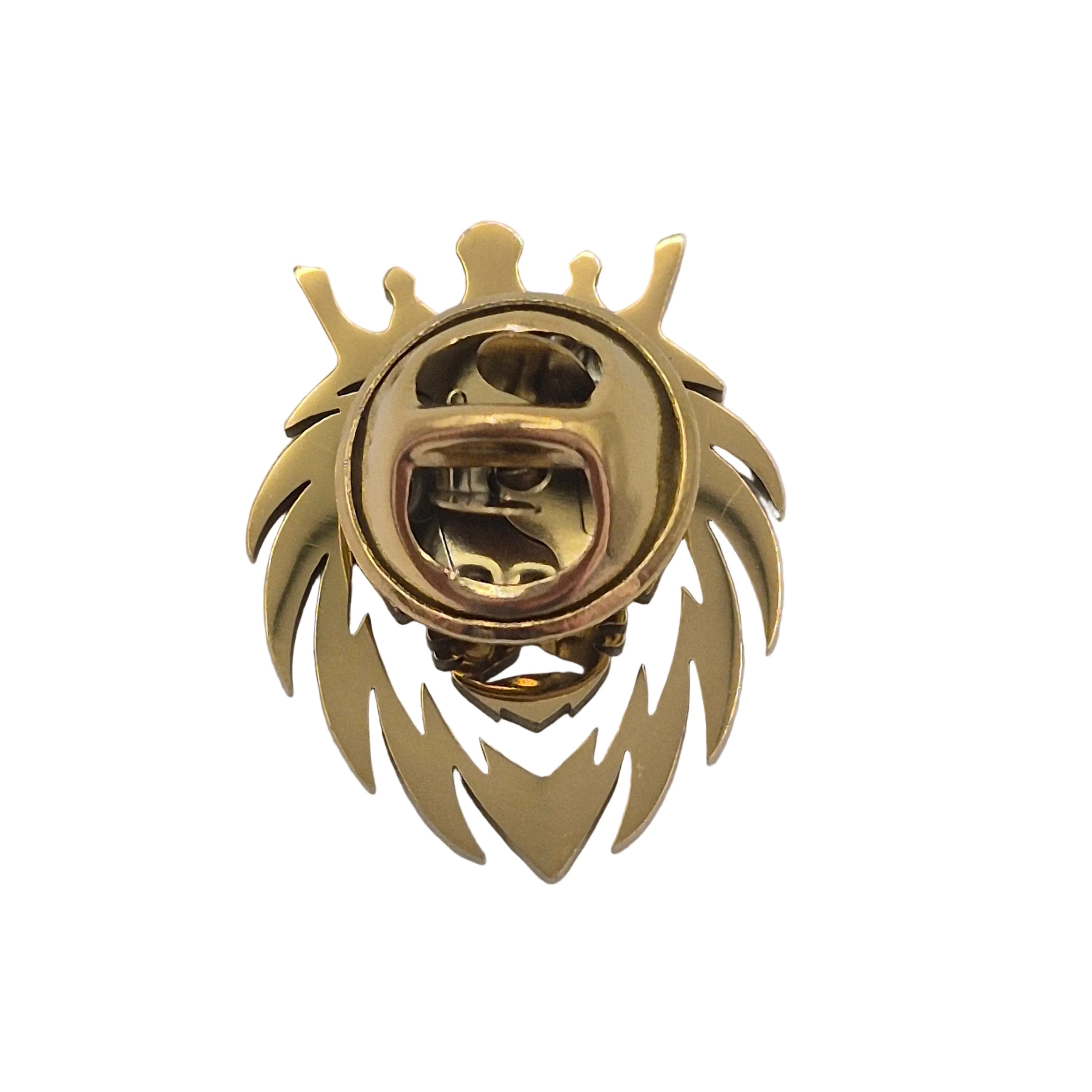 A gold-colored metal brooch shaped like a lion's head, displayed on a plain white background.