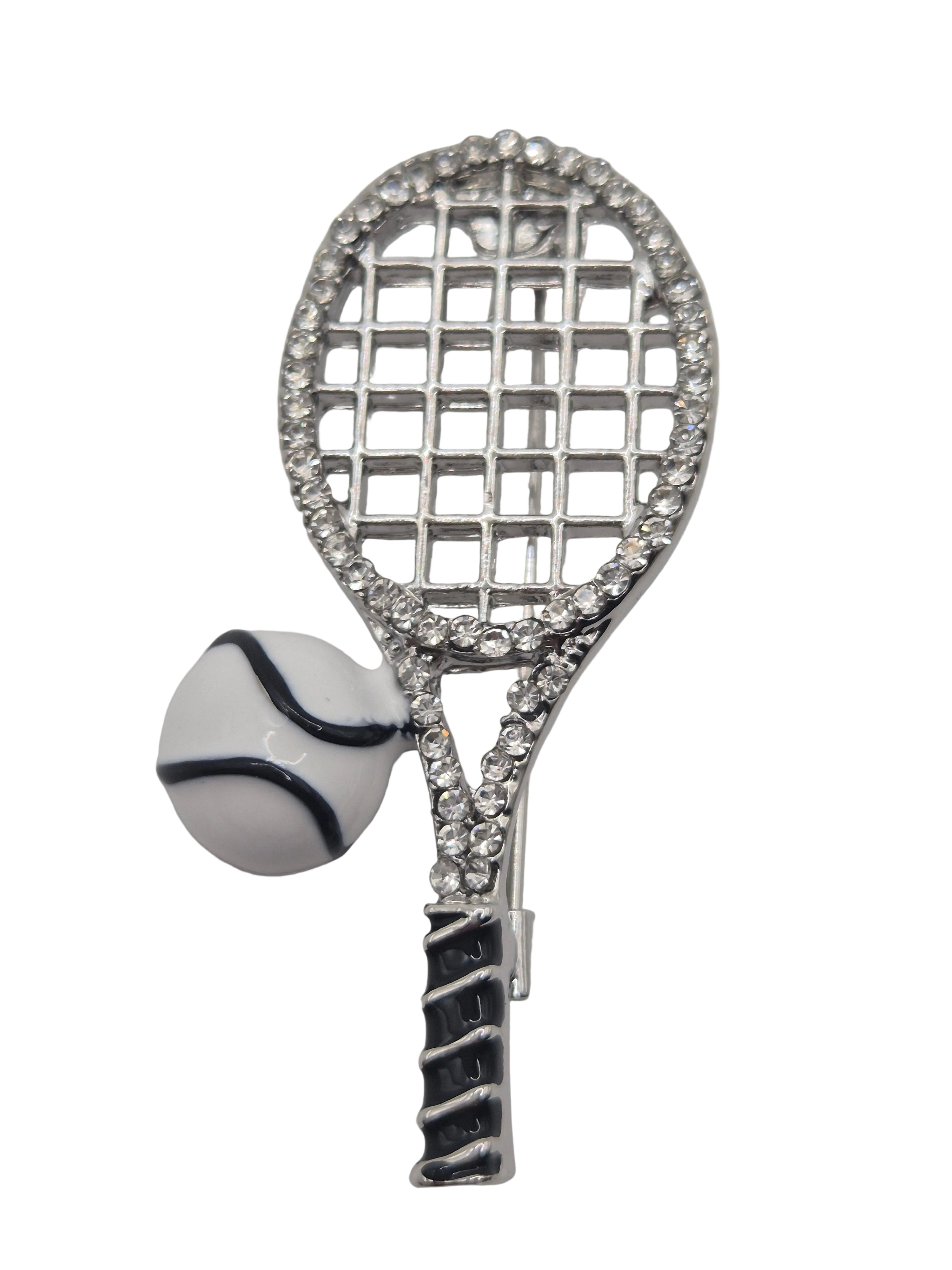 Tennis racket and ball brooch on a white background