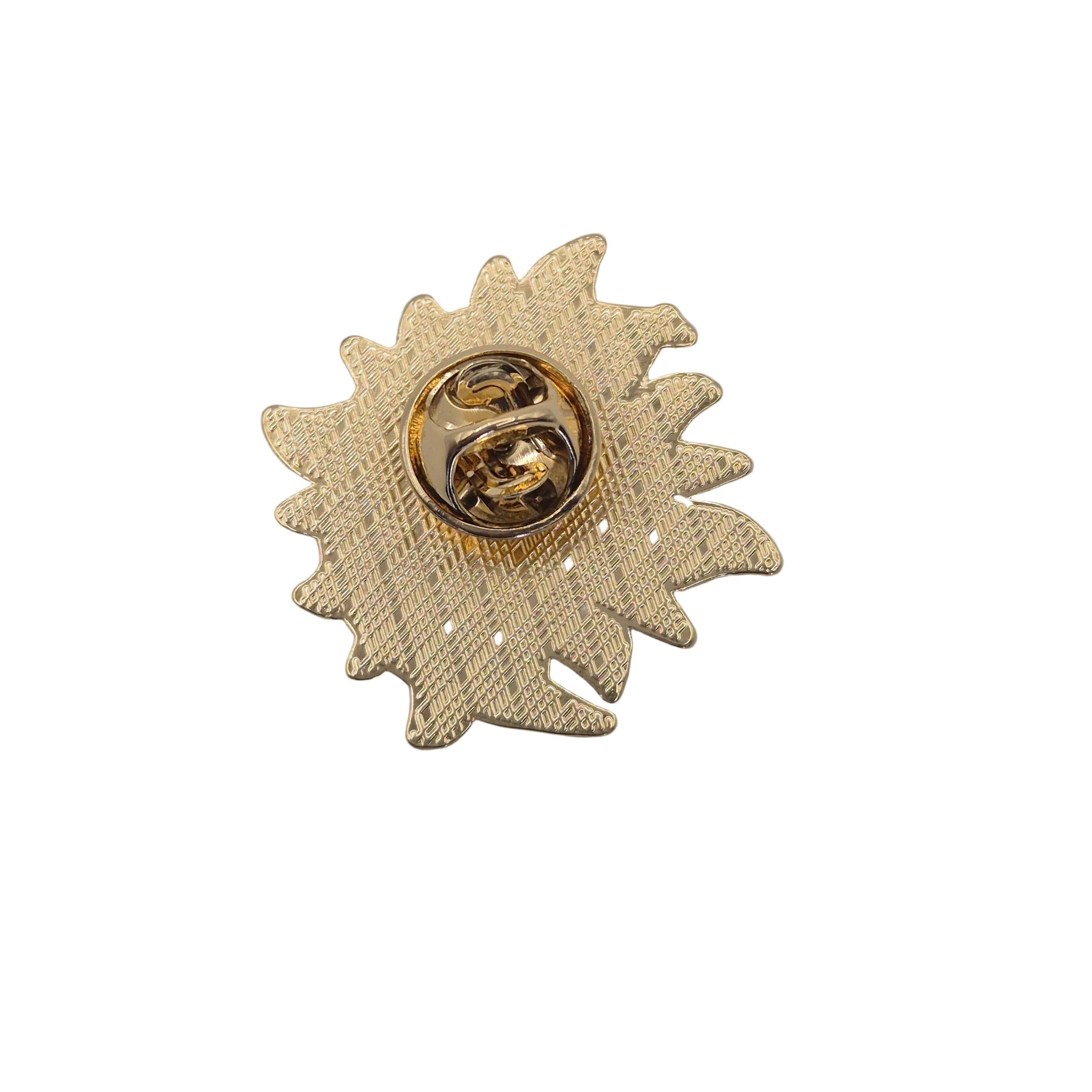 A gold-toned enamel pin shaped like a stylized sun and moon, featuring a textured herringbone pattern and a shiny circular pin clasp in the center, shown on a plain white background.