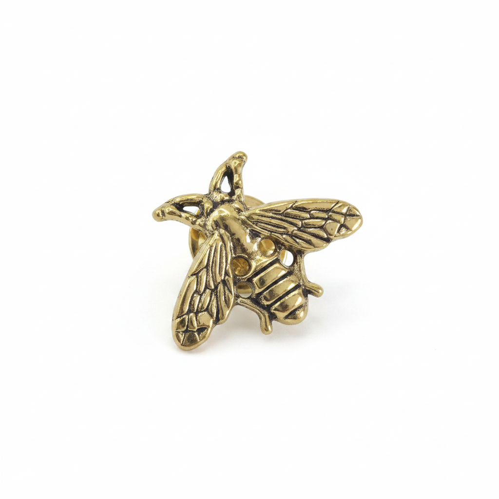 A small metallic bee pin brooch with an antique gold finish, shown against a plain white background.