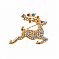 A gold reindeer brooch embellished with clear rhinestones and accented with small multicolored gemstones on its antlers, shown against a plain white background.