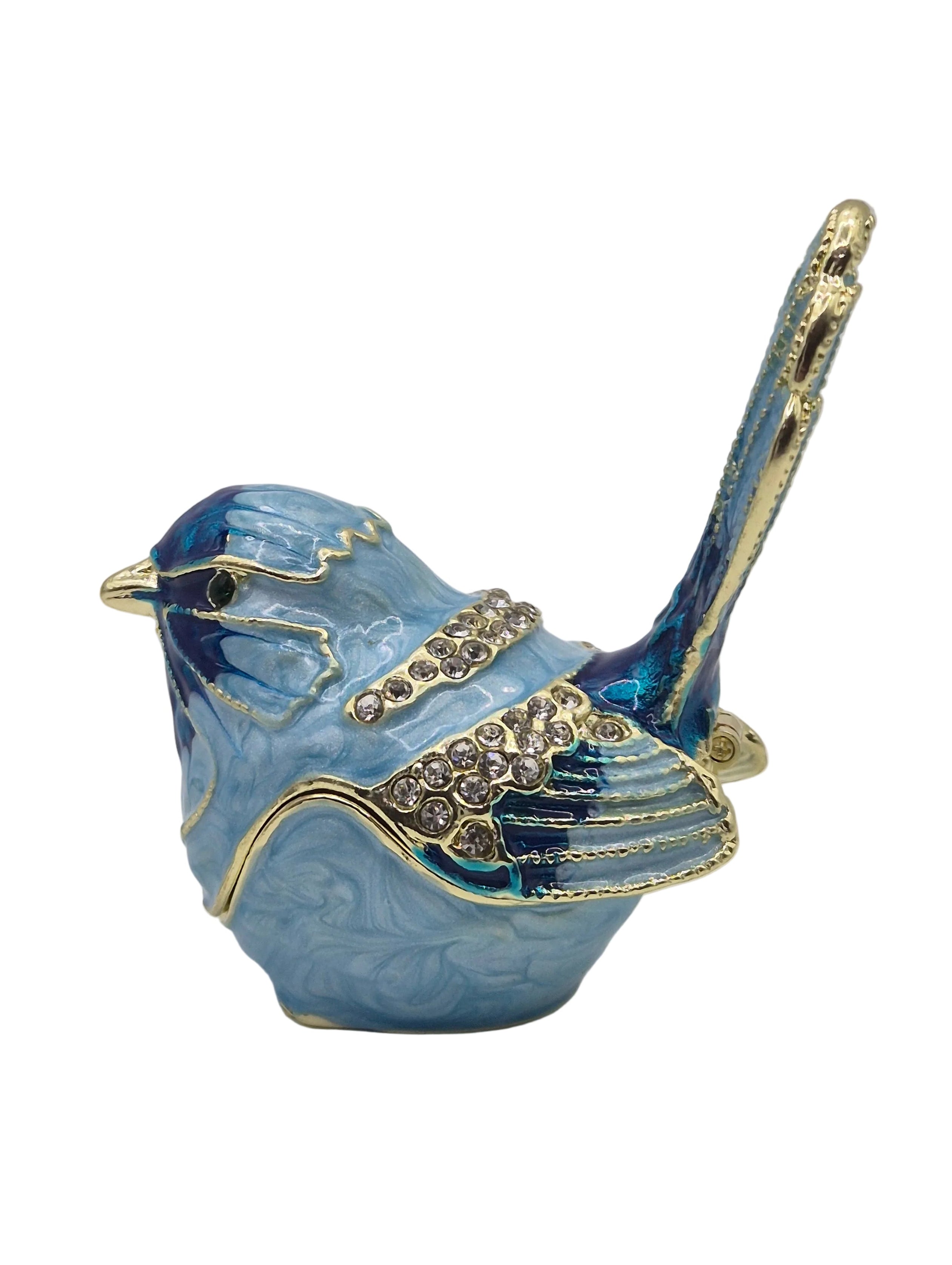 Decorative blue bird trinket pot with gold accents on a white background