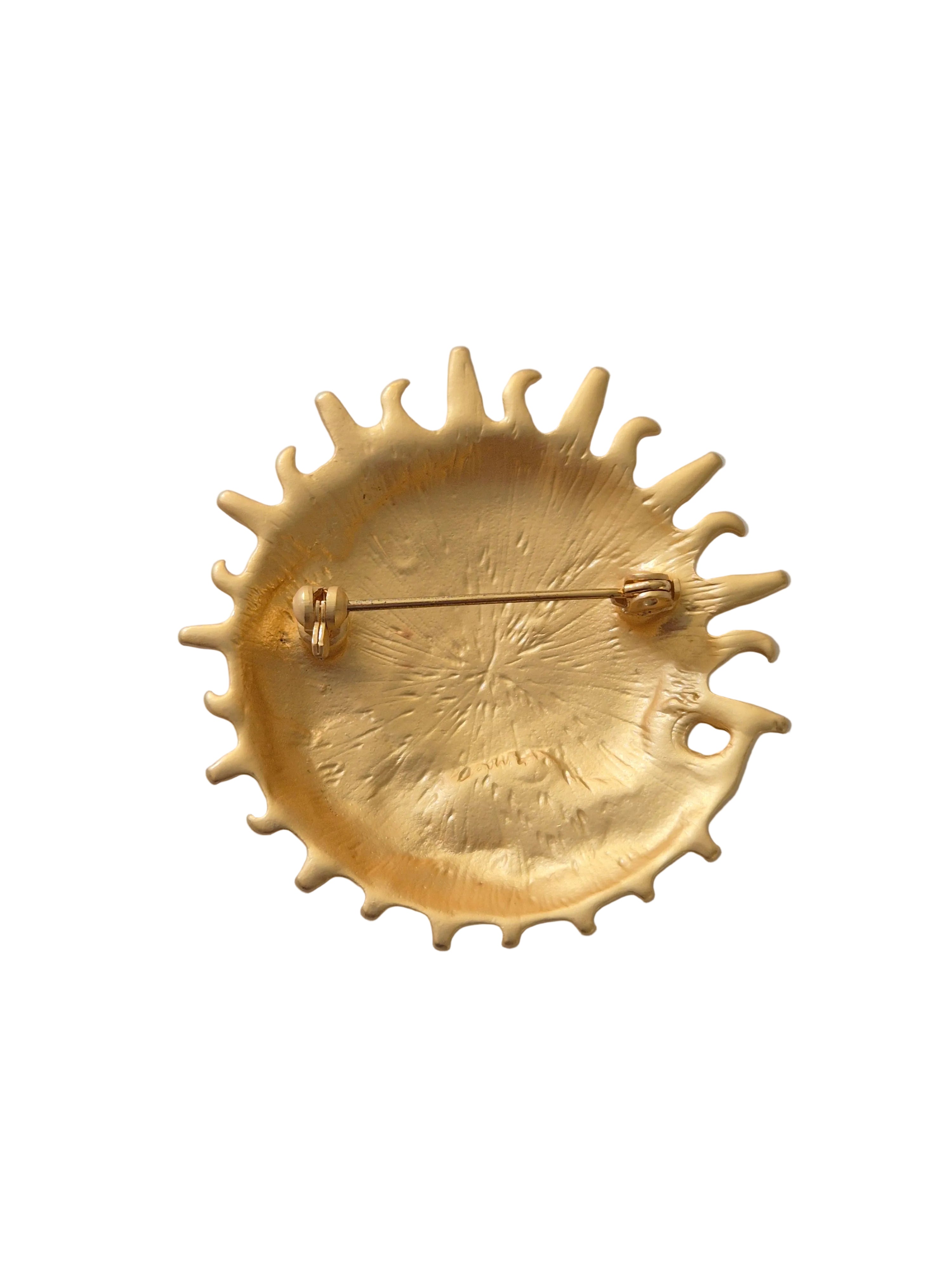 Gold sun moon brooch on a white background