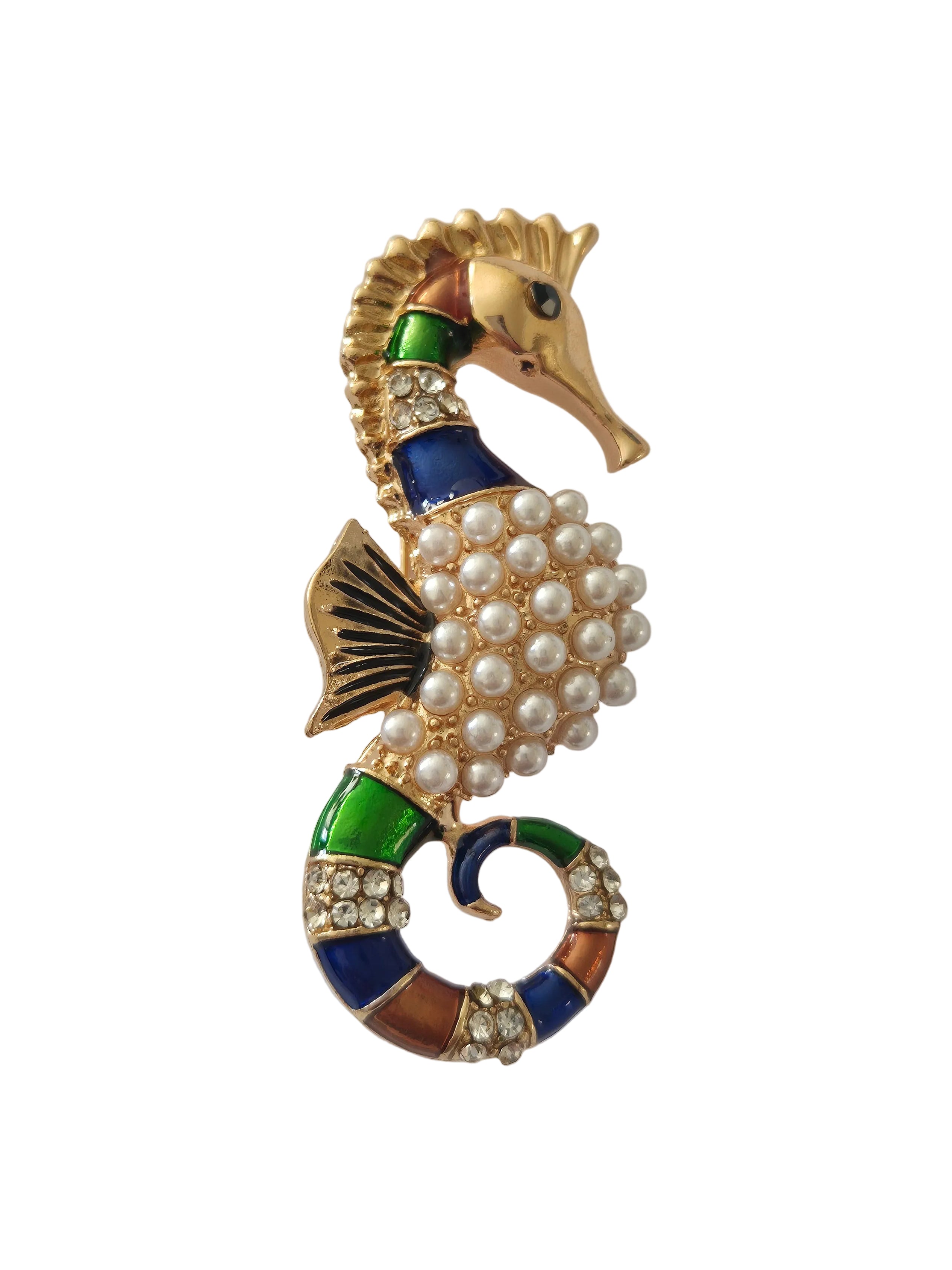 seahorse brooches on a light gray background