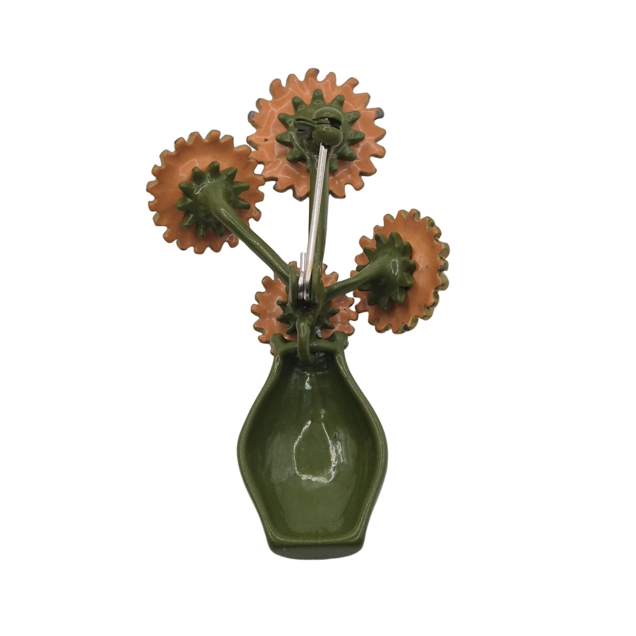 A vintage-style brooch featuring a glossy olive green vase-like base with four flower heads in a terracotta orange-brown color, set against a plain white background.