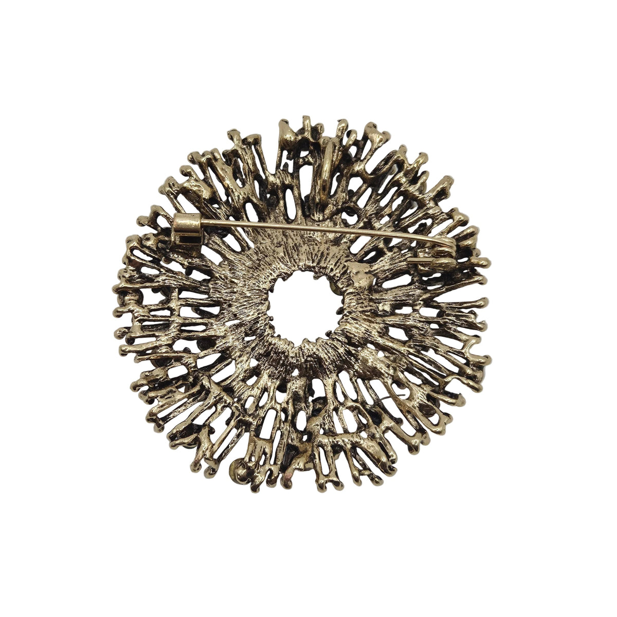 Reverse side of an antique gold tone metal firework brooch, displayed against a plain white background.
