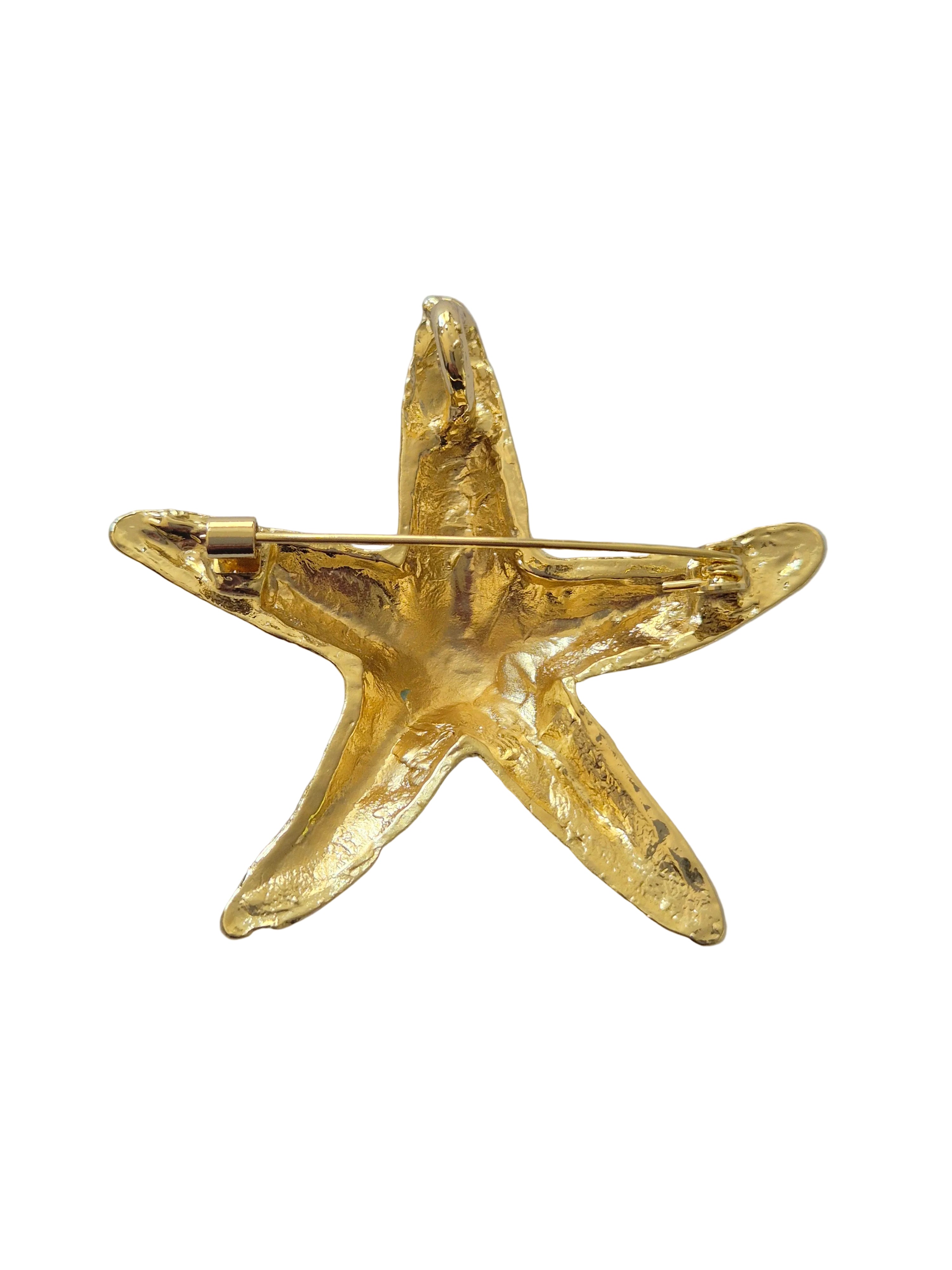 starfish-shaped brooch on a white background