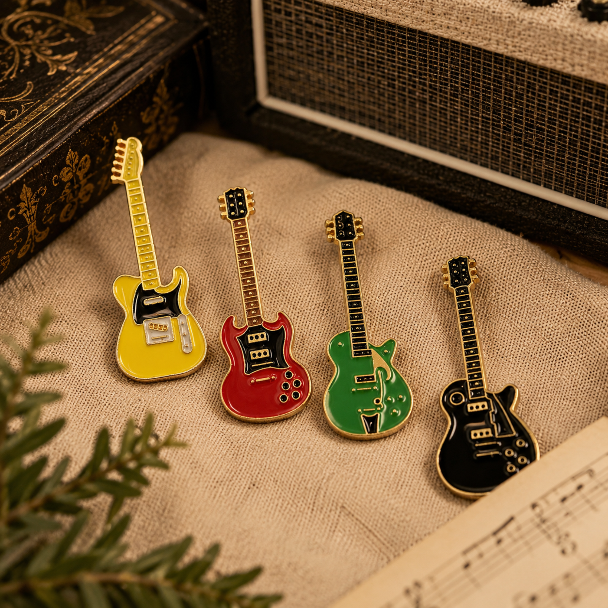 Collection of colourful electric guitar enamel pins displayed on natural linen with a vintage amplifier, sheet music and classic music-themed décor, creating a warm, stylish Shopify lifestyle image for music lovers.