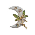 A fairy and crescent moon brooch featuring a gold-toned fairy with glittery green wings, set against a white crescent moon with small iridescent star accents, on a plain white background.
