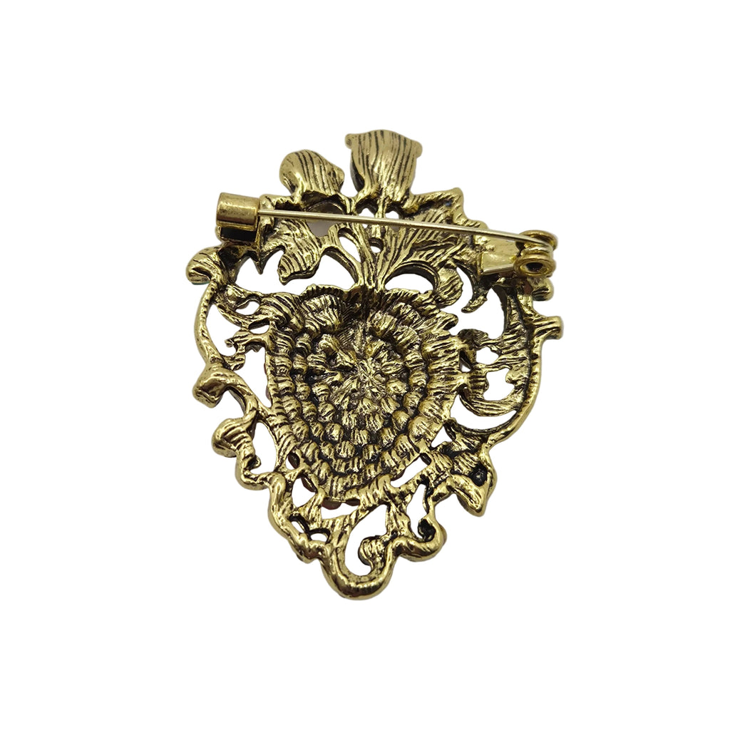 Gold-tone metal brooch with an intricate floral filigree design and pin fastening, shown on a plain white background.