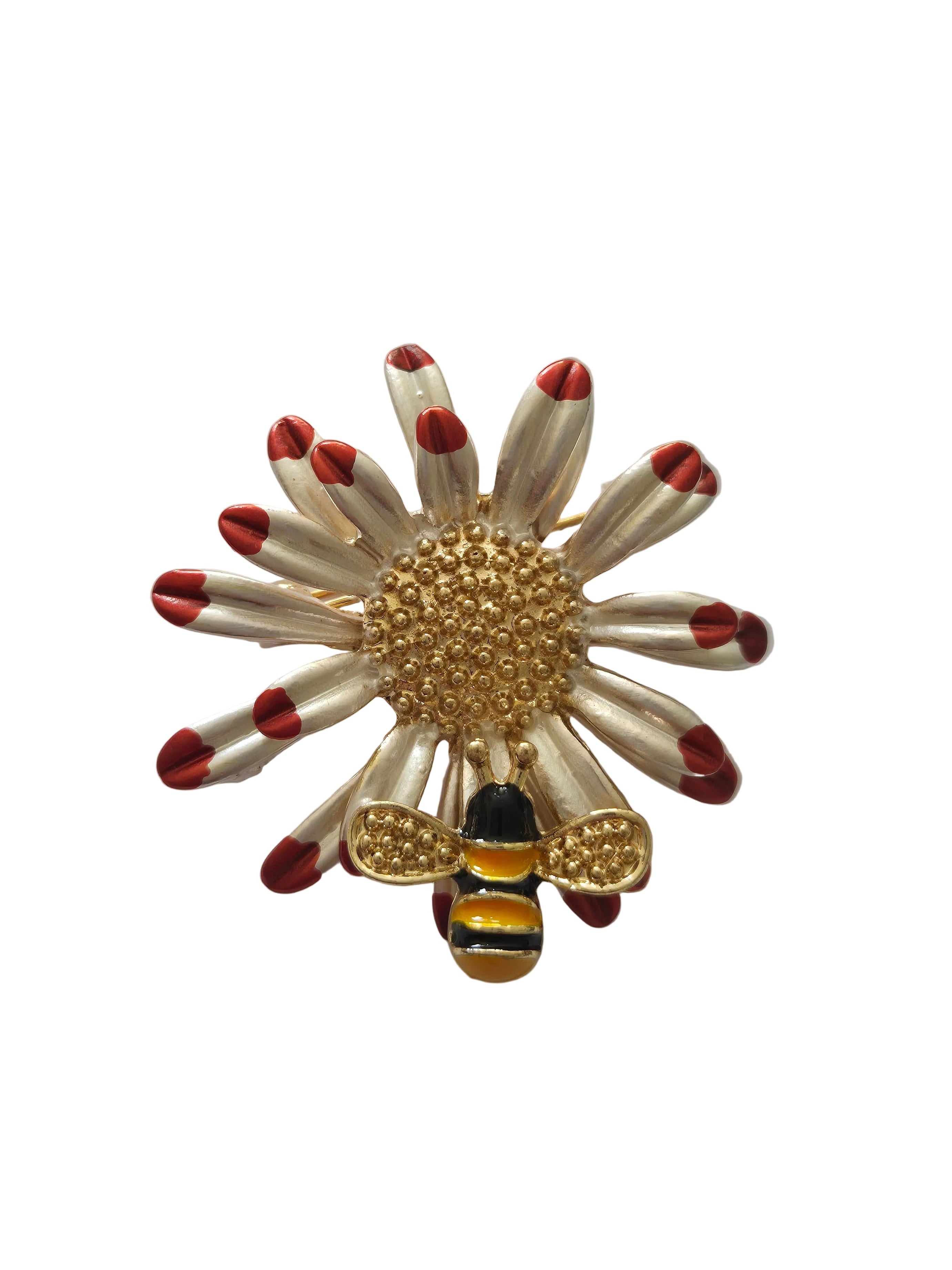Brooch with a floral design and a bee on a white background