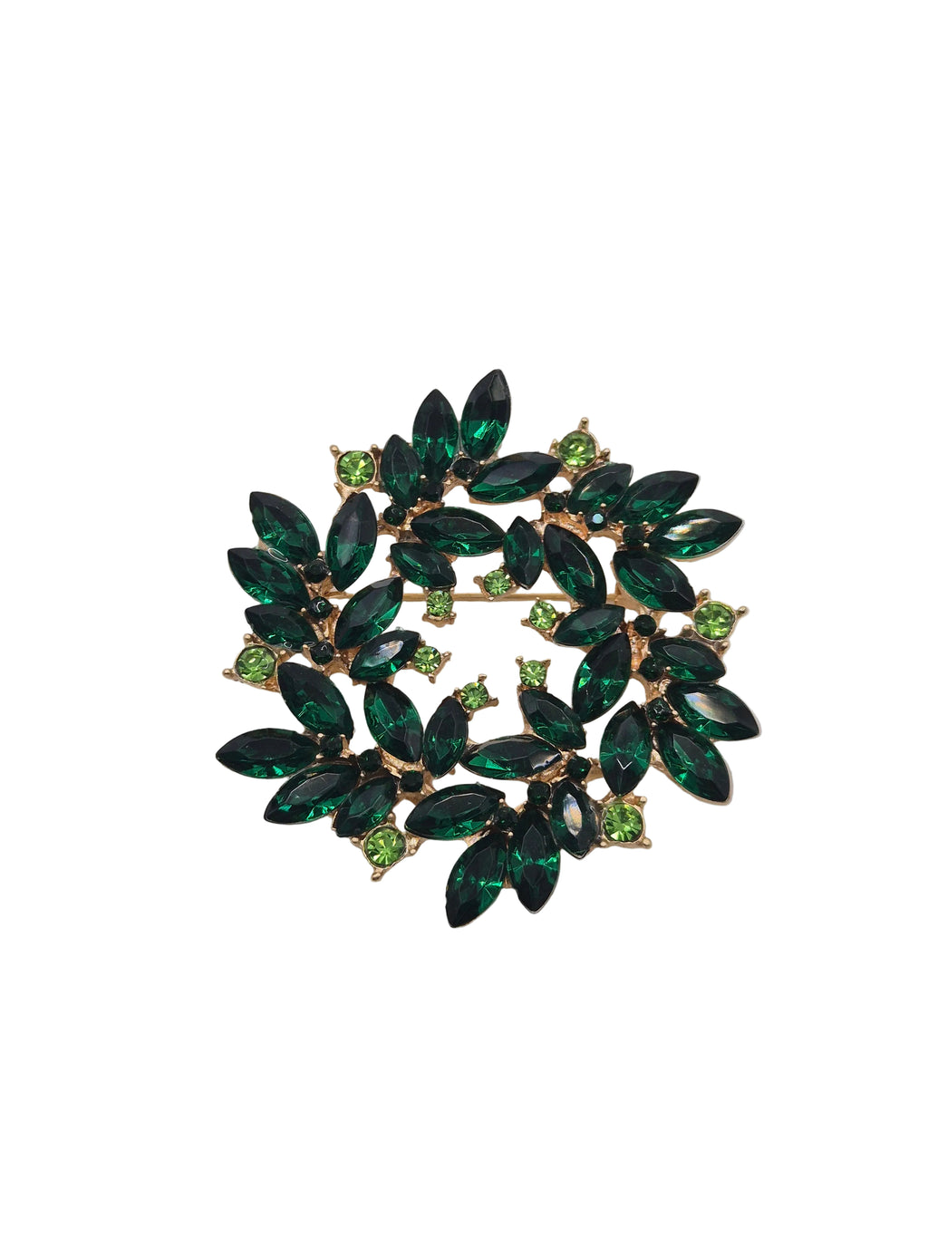 Green gemstone brooch on a gray background