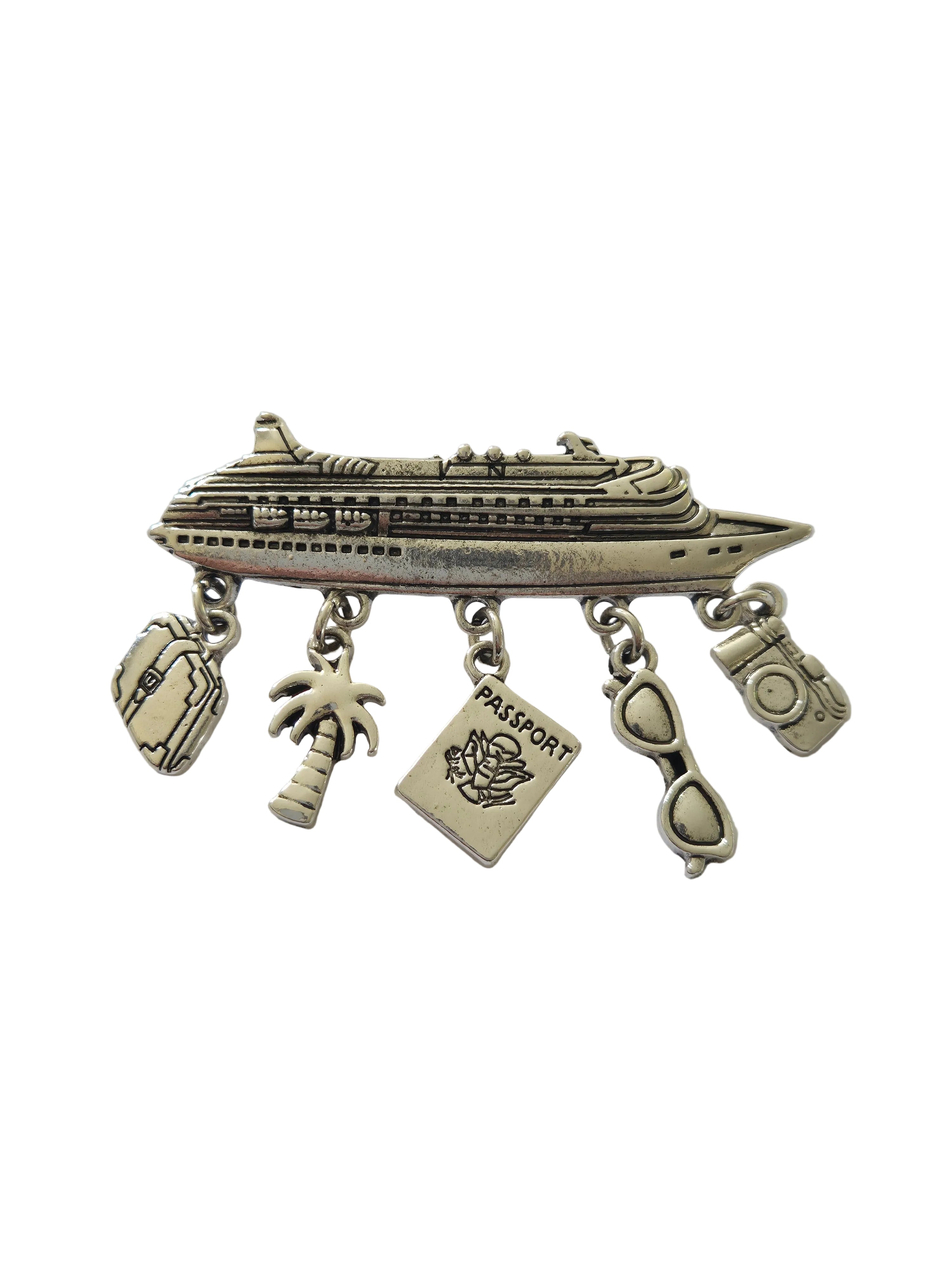 Silver charm brooch with various charms on a light gray background