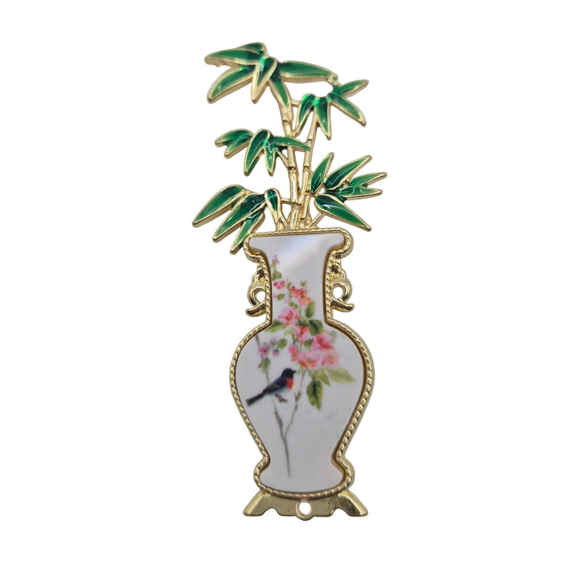 A decorative enamel pin shaped like a white porcelain vase with gold trim, pink flowers, a small bird, and green bamboo leaves on a white background.