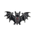 A gothic-style bat brooch or pin featuring a black enamel body, silver rhinestone-embellished wings and outline, and a small red gemstone at the centre, shown on a plain white background.