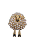Sheep brooch with pearl-like beads on a white background