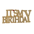 Gold 'It's My Birthday' brooch with rhinestones on a light gray background