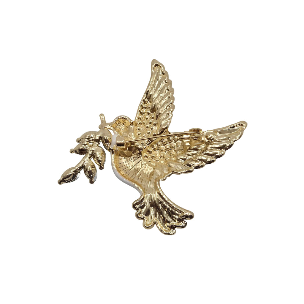 A gold-colored metal bird brooch, shaped like a dove in flight holding an olive branch, displayed on a neutral plain white background.