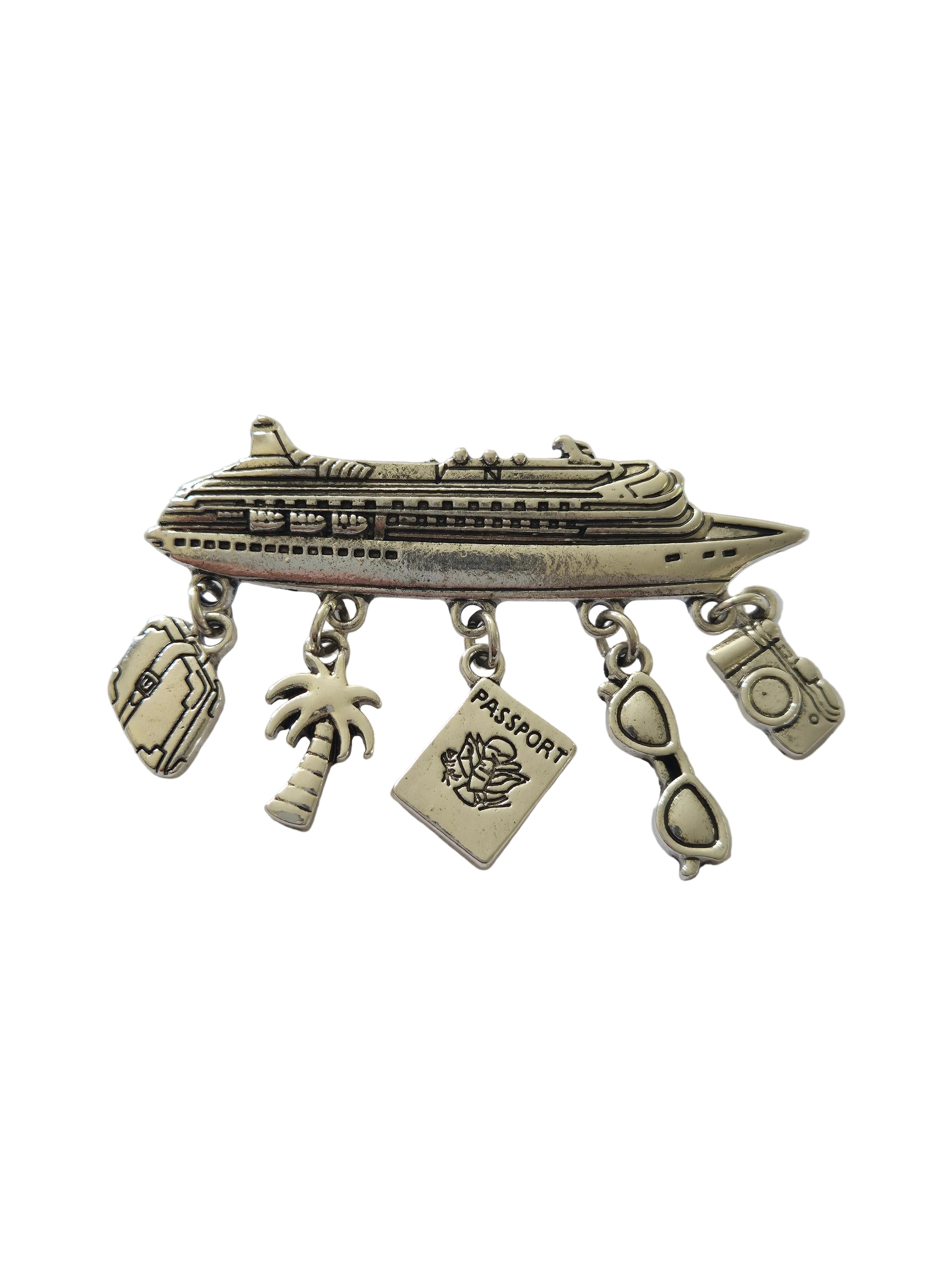 Silver charm brooch with various charms on a light gray background