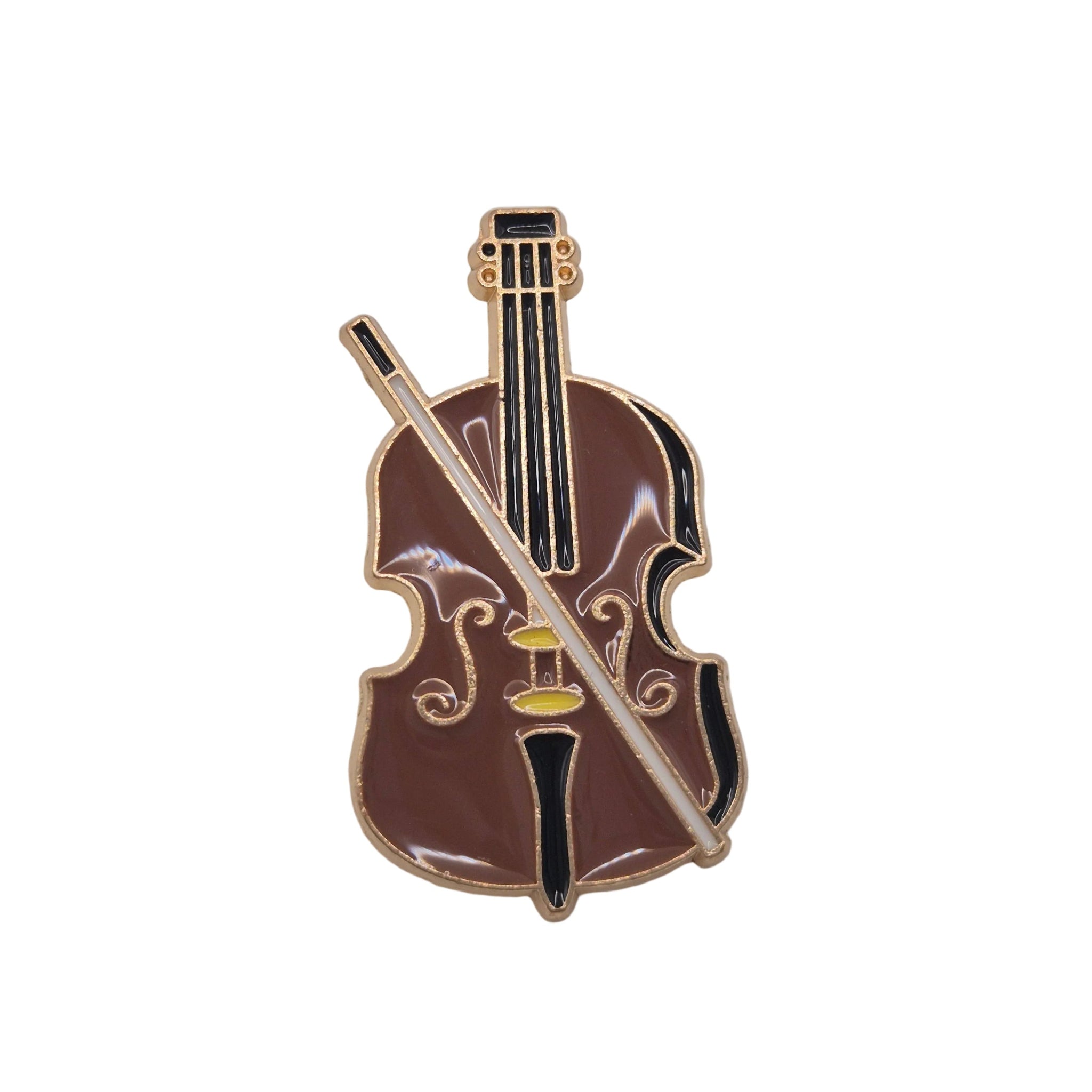 A violin-shaped enamel pin with a brown body, black neck and f-hole details, gold trim, and a white bow, shown on a plain white background.