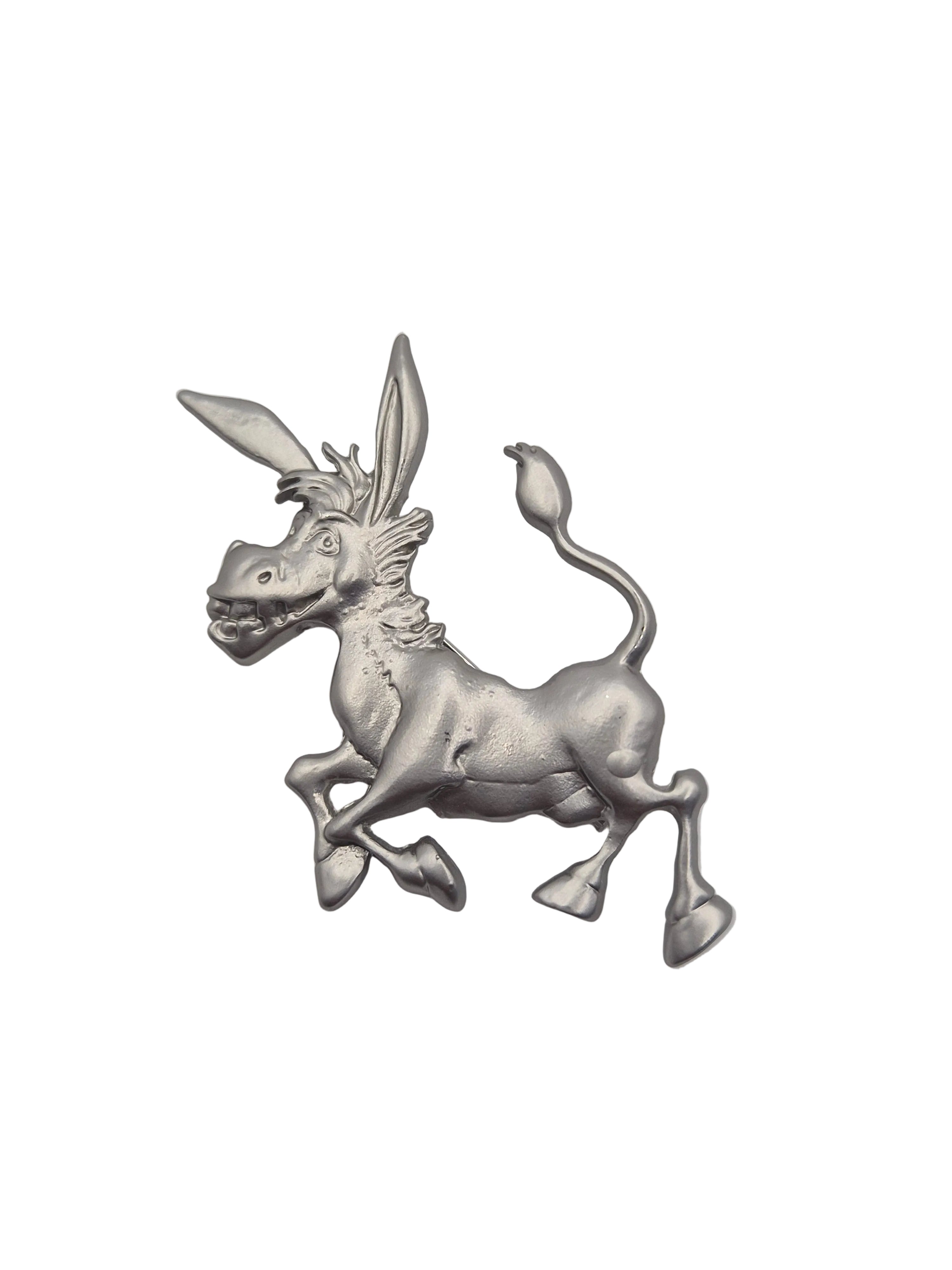 A silver-toned metal brooch shaped like a running donkey, shown on a plain white background.