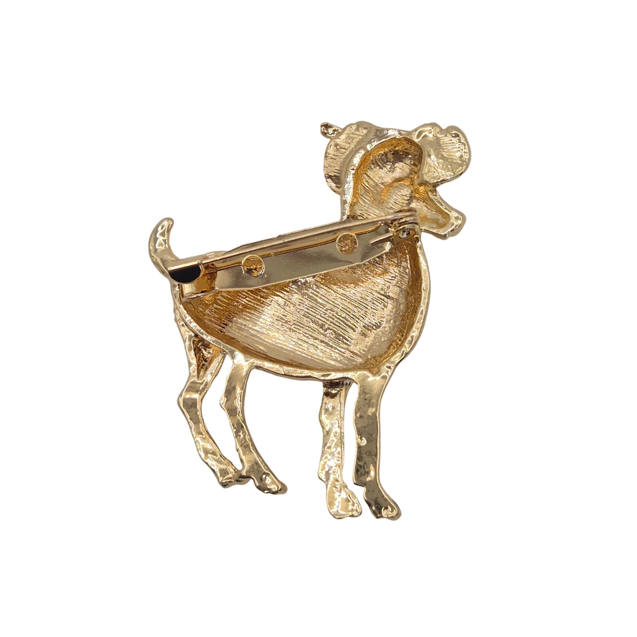 A gold-tone aries ram shaped brooch showing the pin mechanism on the back, photographed against a plain white background.