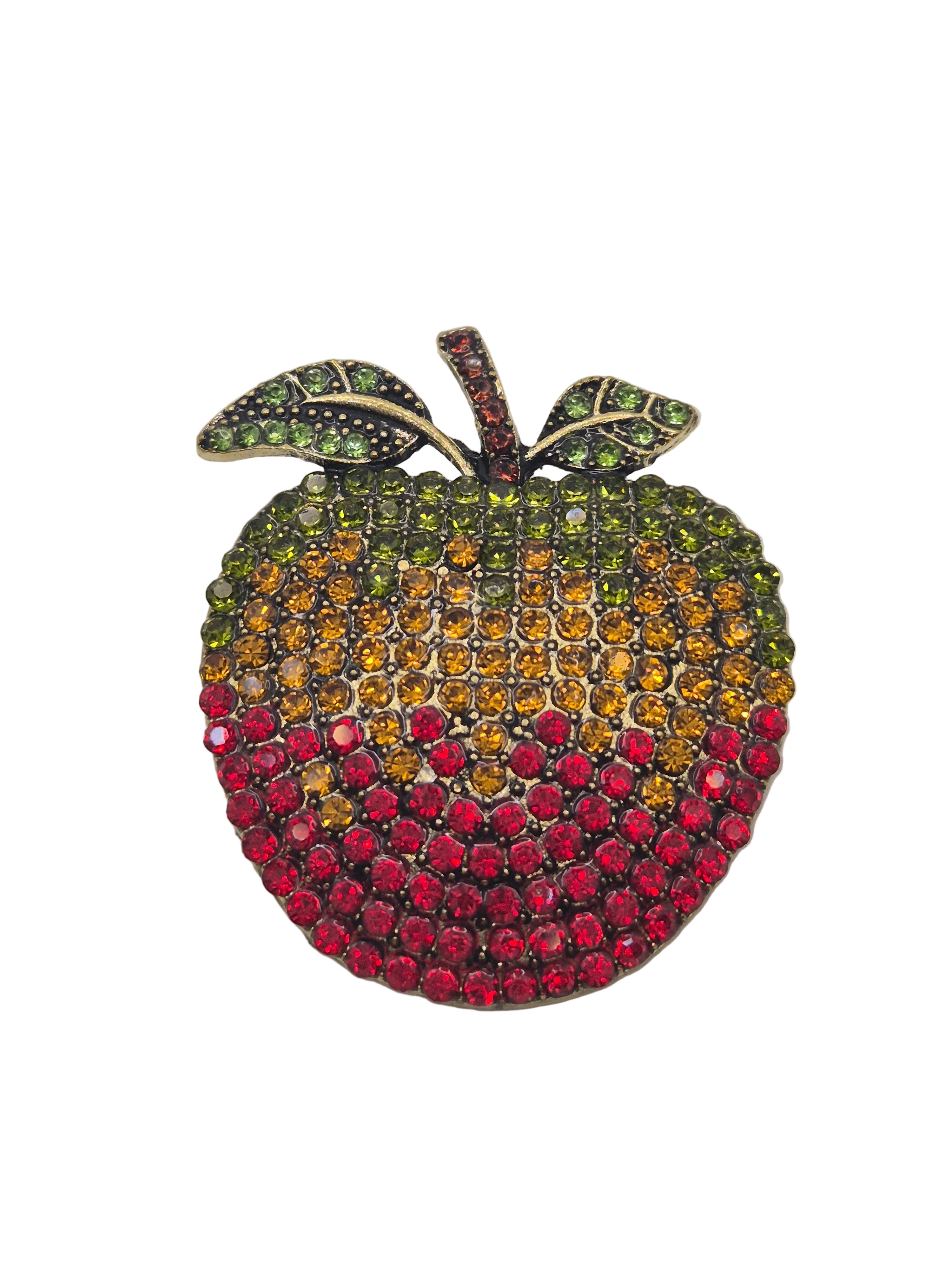 Jeweled apple brooch with multicolored stones on a gray background