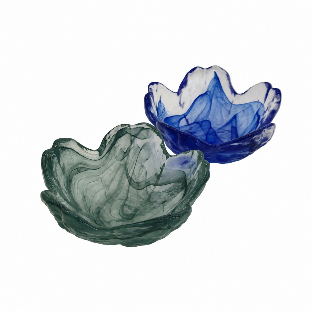 Two flower-shaped glass bowls with marbled swirls, one in translucent smoky green and the other in translucent cobalt blue, shown on a solid white background.