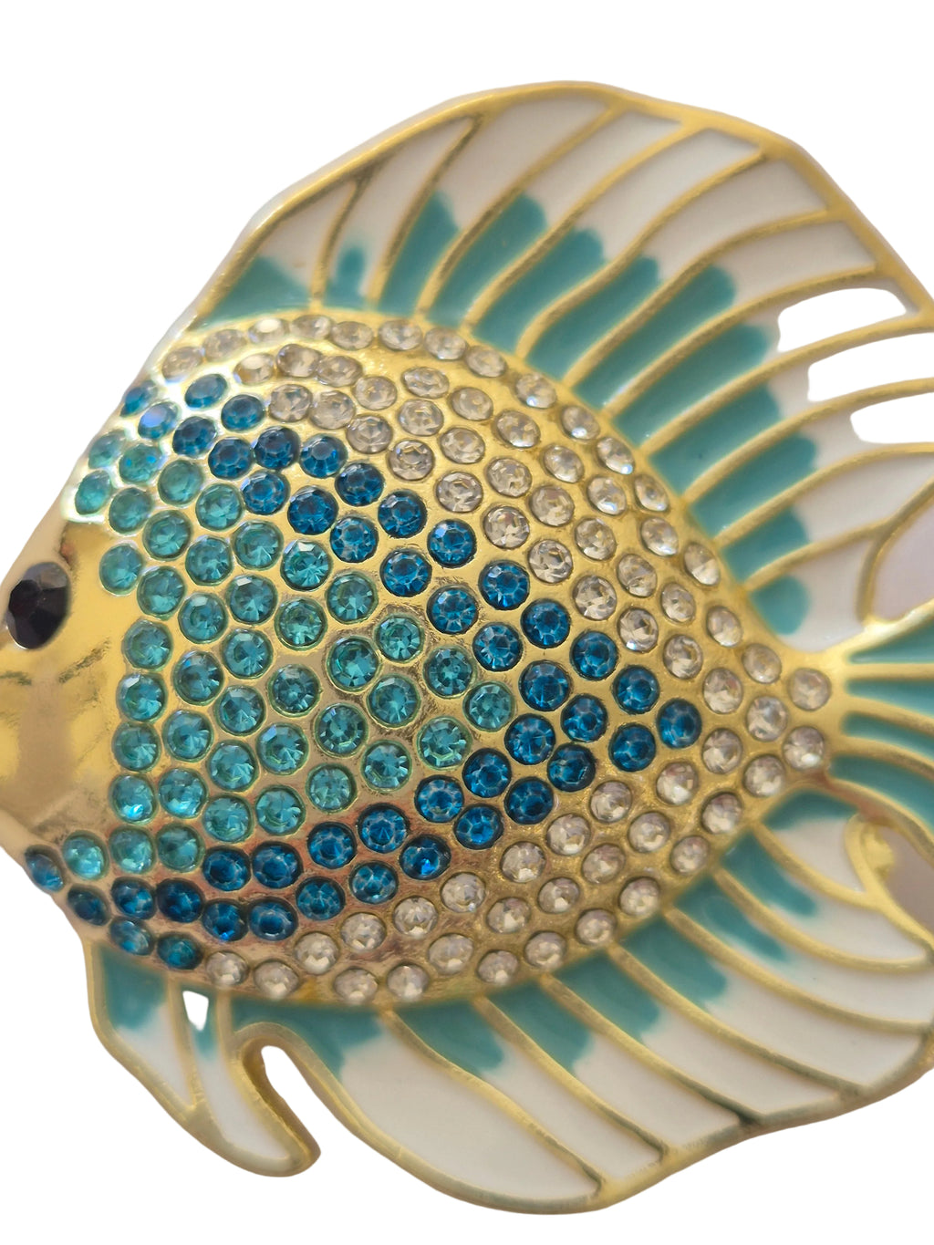 Decorative fish brooch with blue and gold details on a white background